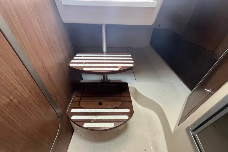 Slide: The Image of Interior of 2012 Boston Whaler 285 Conquest boat with wooden steps and modern design. - 5