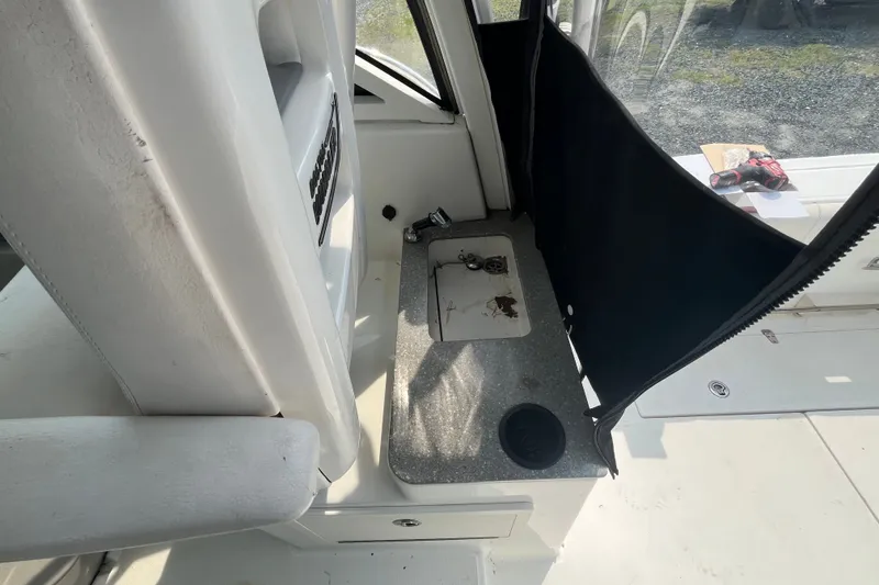 Slide: The Image of Interior view of a 2012 Boston Whaler 285 Conquest boat, featuring a compact sink area. - 16