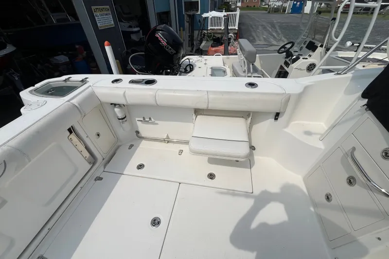 Slide: The Image of 2012 Boston Whaler 285 Conquest boat interior with seating and storage compartments. - 10
