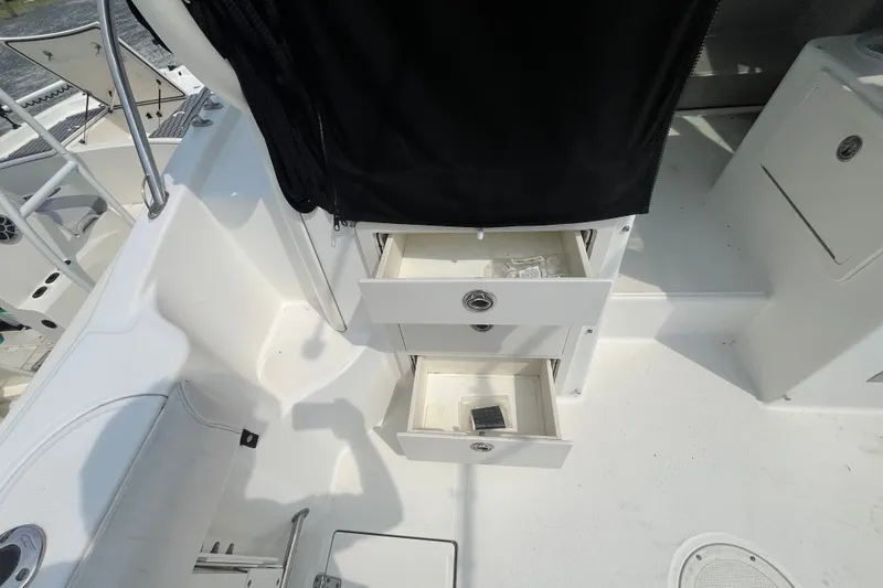 Slide: The Image of 2012 Boston Whaler 285 Conquest boat interior with open storage drawers. - 11