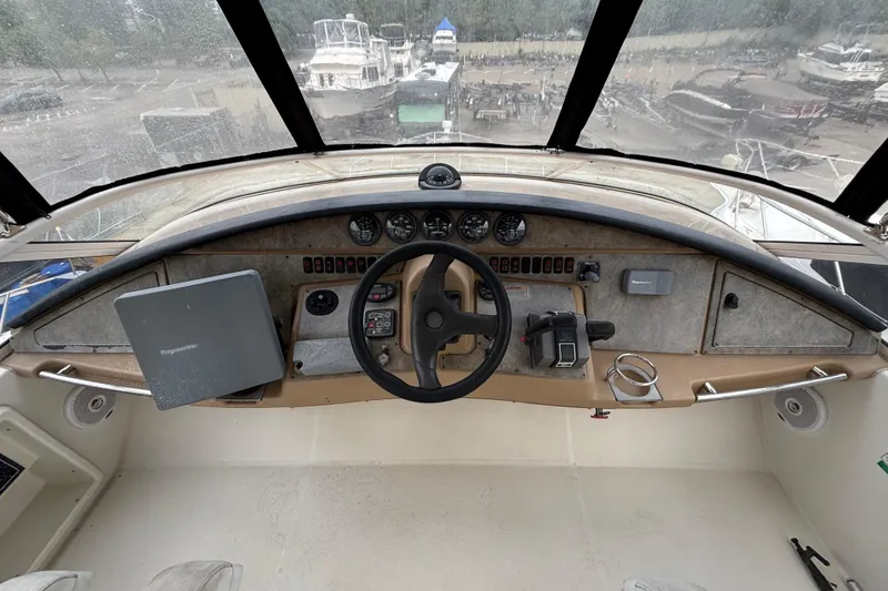 Slide: The Image of 2004 Carver 360 Sport Sedan helm with steering wheel, gauges, and navigation equipment. - 7