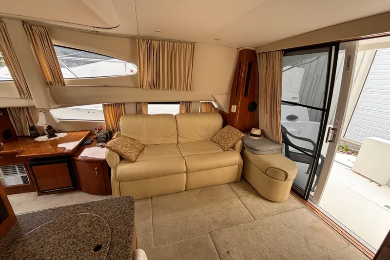 Slide: The Image of Interior of 2004 Carver 360 Sport Sedan with beige sofa and wooden accents. - 10