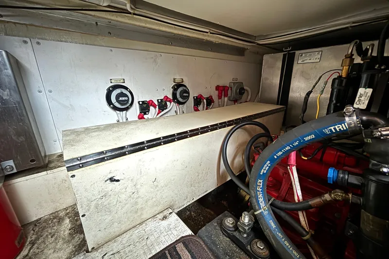 Slide: The Image of Engine room of a 2004 Carver 360 Sport Sedan with visible hoses and controls. - 18