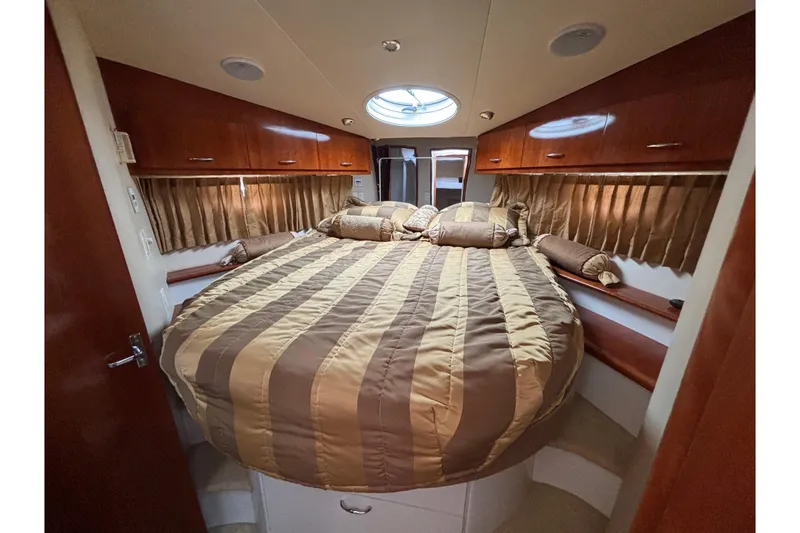 Slide: The Image of Luxurious bedroom interior of 2004 Carver 360 Sport Sedan yacht with striped bedding. - 14