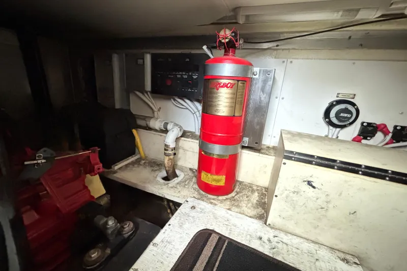 Slide: The Image of Engine room of 2004 Carver 360 Sport Sedan with fire extinguisher and control panel. - 17