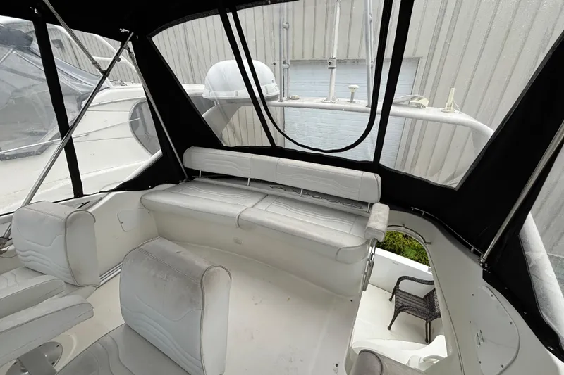 Slide: The Image of 2004 Carver 360 Sport Sedan interior with white seating and black canopy. - 5