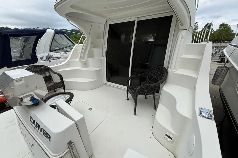 Slide: The Image of 2004 Carver 360 Sport Sedan yacht deck with seating and stairs. - 4