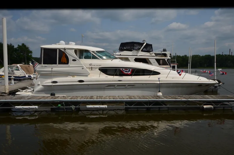Slide: The Image of 2004 Sea Ray 480 Motor Yacht docked at marina, decorated with flags. - 5