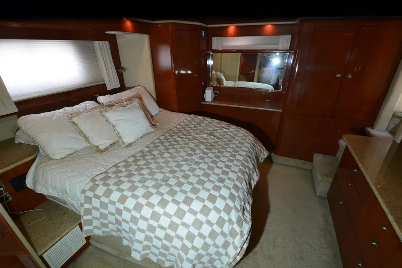 Slide: The Image of Luxurious bedroom interior of 2004 Sea Ray 480 Motor Yacht with elegant wood finishes. - 25