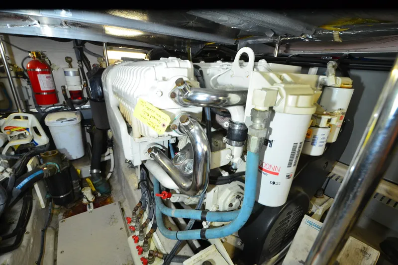 Slide: The Image of Engine room of a 2004 Sea Ray 480 Motor Yacht, showcasing mechanical components and equipment. - 49