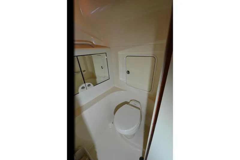 Slide: The Image of 2004 Sea Ray 480 Motor Yacht bathroom with toilet and mirrored cabinet. - 26