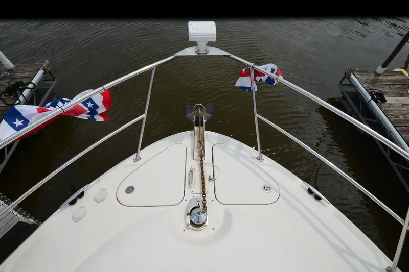 Slide: The Image of Bow view of 2004 Sea Ray 480 Motor Yacht with nautical flags and anchor. - 11