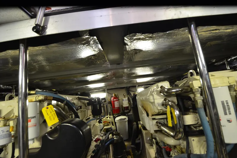Slide: The Image of Engine room of a 2004 Sea Ray 480 Motor Yacht, featuring mechanical components and insulation. - 52