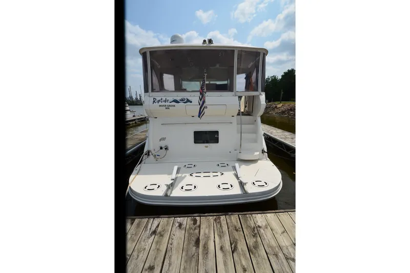 Slide: The Image of 2004 Sea Ray 480 Motor Yacht docked, rear view with clear skies. - 8