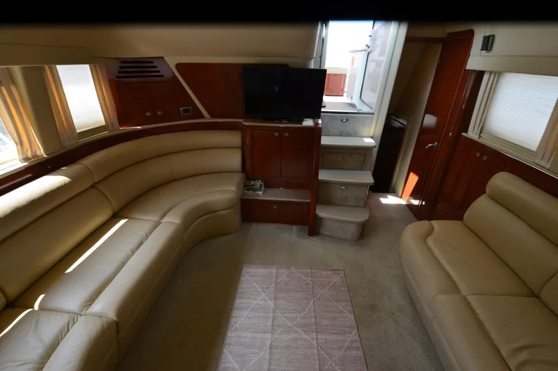 Slide: The Image of Luxurious interior of a 2004 Sea Ray 480 Motor Yacht with plush seating and TV. - 38