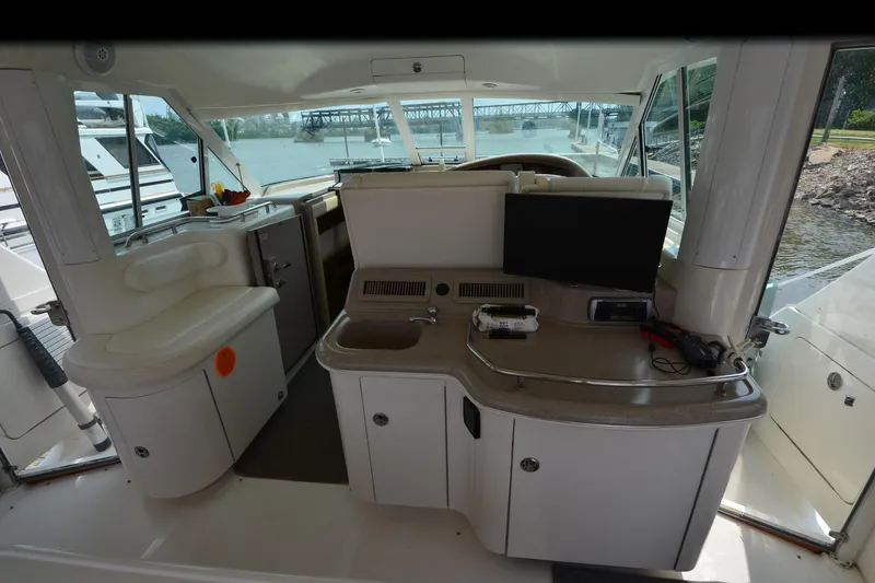 Slide: The Image of 2004 Sea Ray 480 Motor Yacht interior with helm, seating, and control panel. - 19