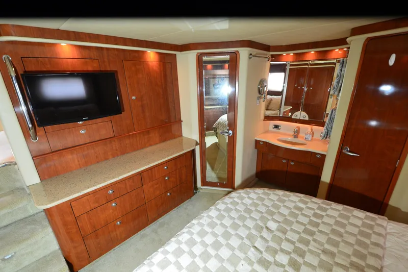 Slide: The Image of Luxurious 2004 Sea Ray 480 Motor Yacht interior with wood cabinetry and modern amenities. - 23