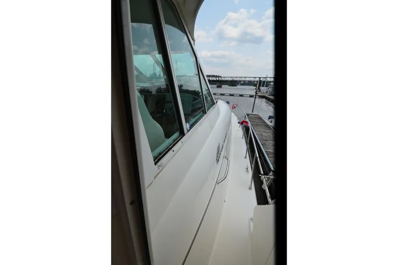 Slide: The Image of 2004 Sea Ray 480 Motor Yacht docked, showcasing sleek design and waterfront view. - 9