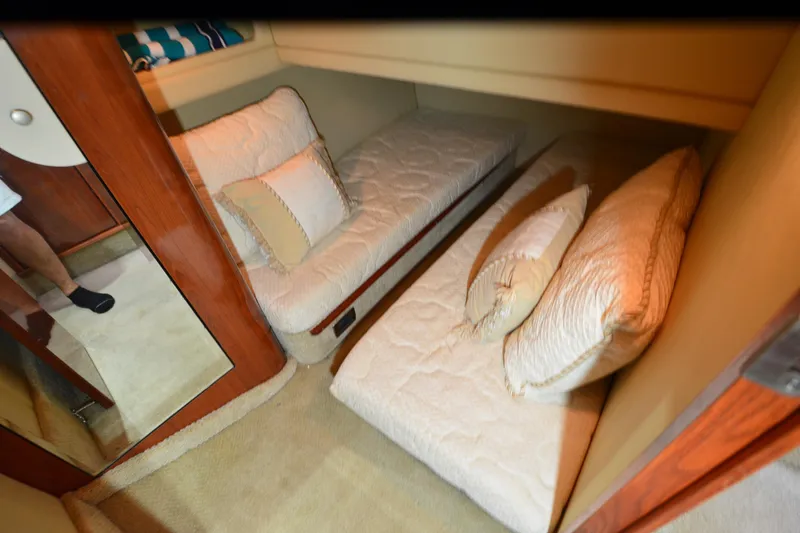 Slide: The Image of 2004 Sea Ray 480 Motor Yacht cabin with twin beds and plush pillows. - 45