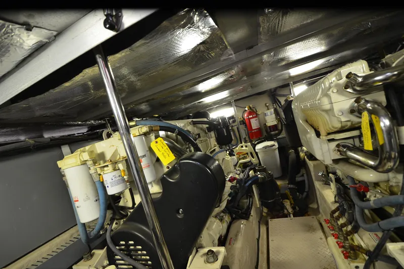 Slide: The Image of Engine room of a 2004 Sea Ray 480 Motor Yacht, showcasing mechanical components and fire extinguisher. - 51