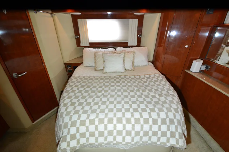 Slide: The Image of Luxurious bedroom interior of 2004 Sea Ray 480 Motor Yacht with elegant wood finishes. - 28
