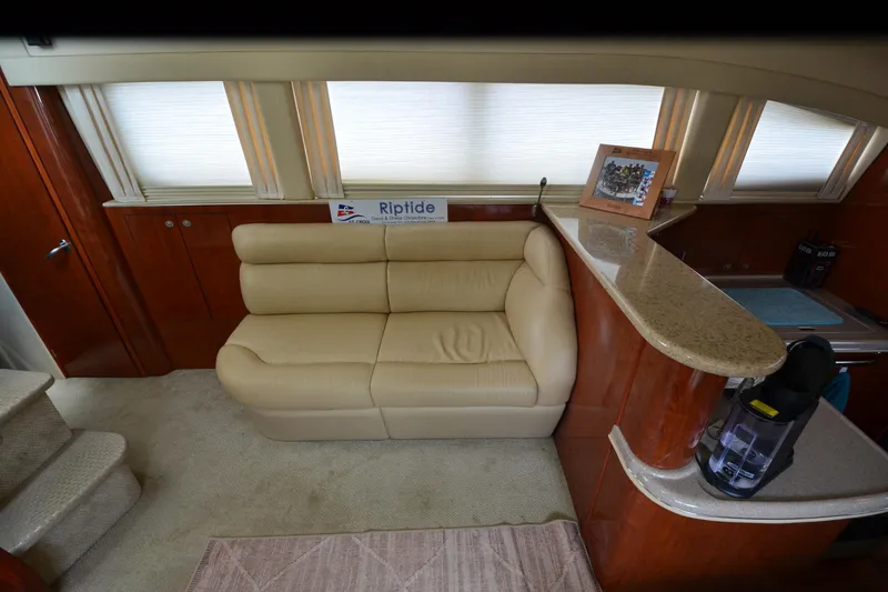 Slide: The Image of Interior of 2004 Sea Ray 480 Motor Yacht with beige sofa and wooden cabinetry. - 40