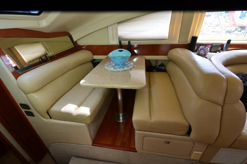 Slide: The Image of Luxurious interior of 2004 Sea Ray 480 Motor Yacht with beige seating and dining table. - 21