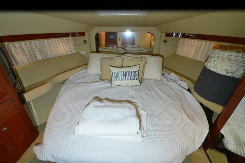 Slide: The Image of Luxurious bedroom interior of 2004 Sea Ray 480 Motor Yacht with cozy bedding. - 30