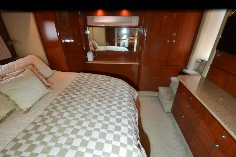 Slide: The Image of Luxurious 2004 Sea Ray 480 Motor Yacht bedroom with elegant wood cabinetry and plush bedding. - 29