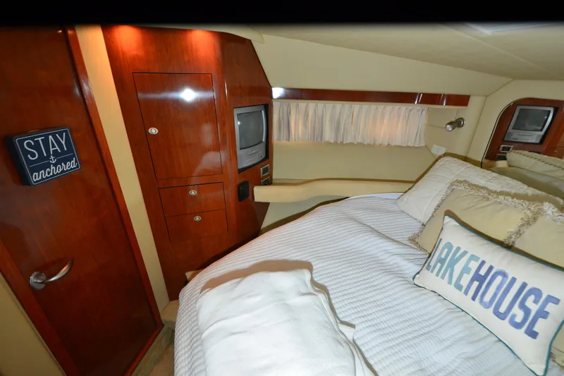 Slide: The Image of Luxurious 2004 Sea Ray 480 Motor Yacht bedroom with cozy bedding and elegant wood finishes. - 31