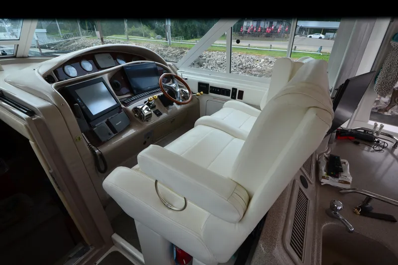 Slide: The Image of Helm of 2004 Sea Ray 480 Motor Yacht with dual screens and leather captain's chair. - 13