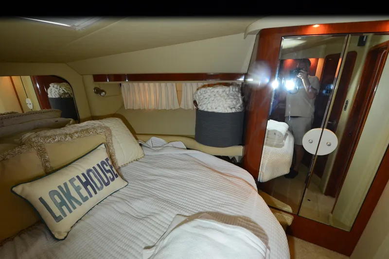 Slide: The Image of Luxurious bedroom interior of 2004 Sea Ray 480 Motor Yacht with cozy bedding and mirrored closet. - 32