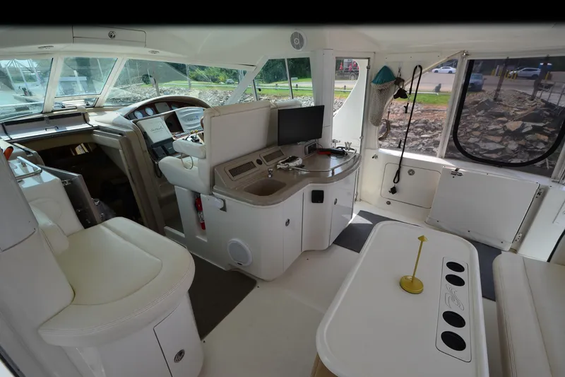 Slide: The Image of Interior of 2004 Sea Ray 480 Motor Yacht with helm, seating, and navigation equipment. - 16