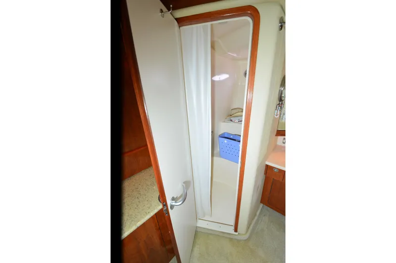Slide: The Image of Shower area in 2004 Sea Ray 480 Motor Yacht, featuring compact design and storage. - 27