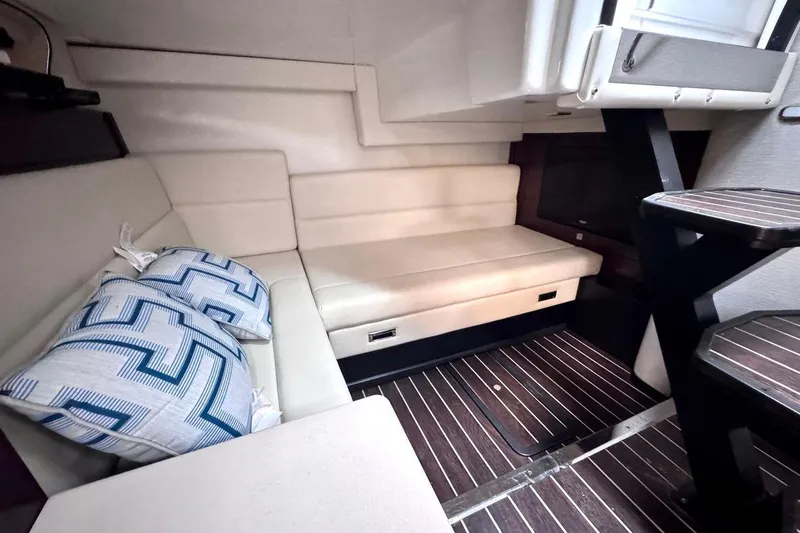Slide: The Image of Interior of 2018 Monterey 335 Sport Yacht with beige seating and striped flooring. - 11