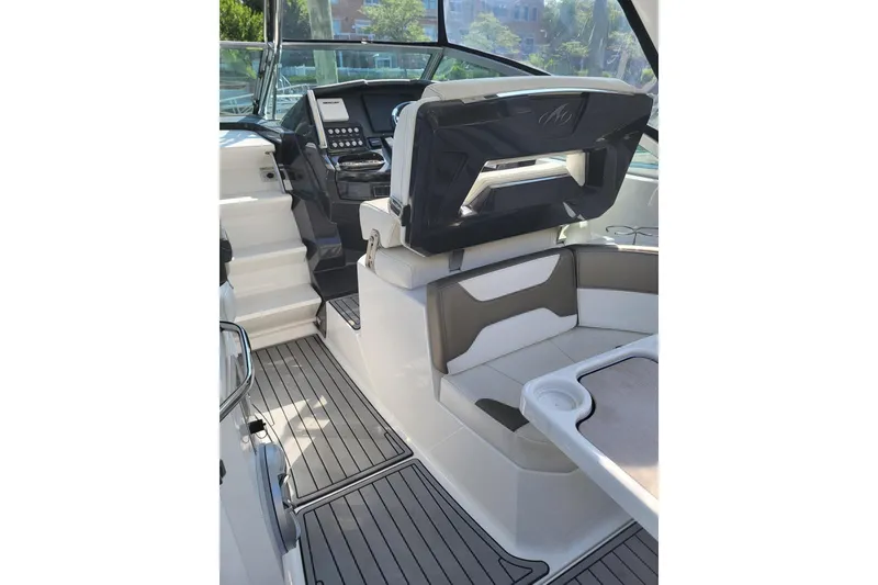 Slide: The Image of Interior of a 2018 Monterey 335 Sport Yacht, featuring sleek seating and modern controls. - 7