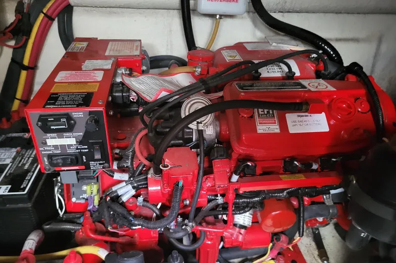 Slide: The Image of Engine compartment of a 2018 Monterey 335 Sport Yacht, featuring a red marine engine. - 17