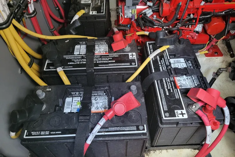 Slide: The Image of Batteries and wiring in a 2018 Monterey 335 Sport Yacht engine compartment. - 18