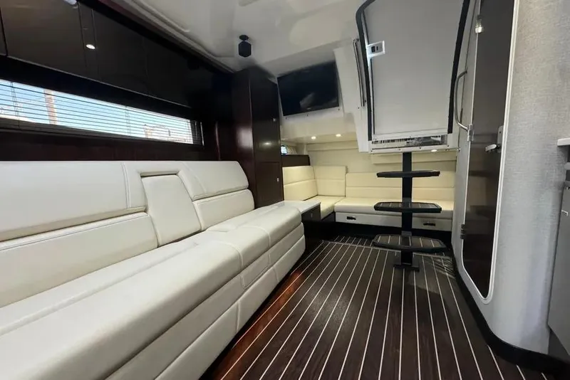 Slide: The Image of Interior of 2018 Monterey 335 Sport Yacht with sleek white seating and modern design. - 10