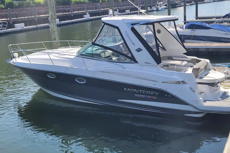 The Image of 2018 Monterey 335 Sport Yacht docked in a marina, showcasing sleek design and modern features. - 0