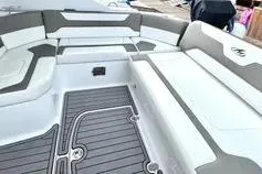 Slide: The Image of The image shows the cockpit of a 2018 Monterey 335 Sport Yacht with gray and white upholstery. - 8
