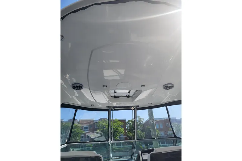 Slide: The Image of 2018 Monterey 335 Sport Yacht interior ceiling with speakers and hatch, showcasing sleek design. - 5