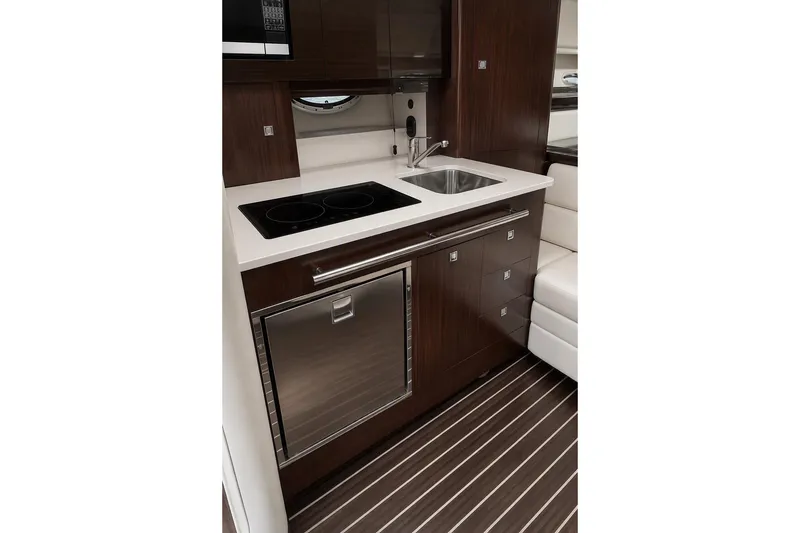 Slide: The Image of Modern kitchen area in 2018 Monterey 335 Sport Yacht with sleek cabinetry and appliances. - 13