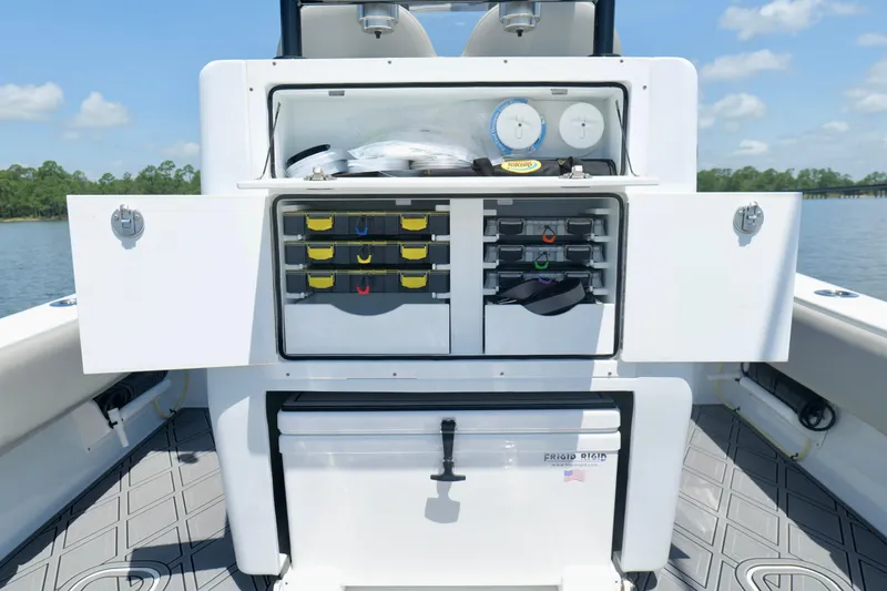 Slide: The Image of 2023 Andros 32 Offshore boat with open storage compartments and organized fishing gear. - 26