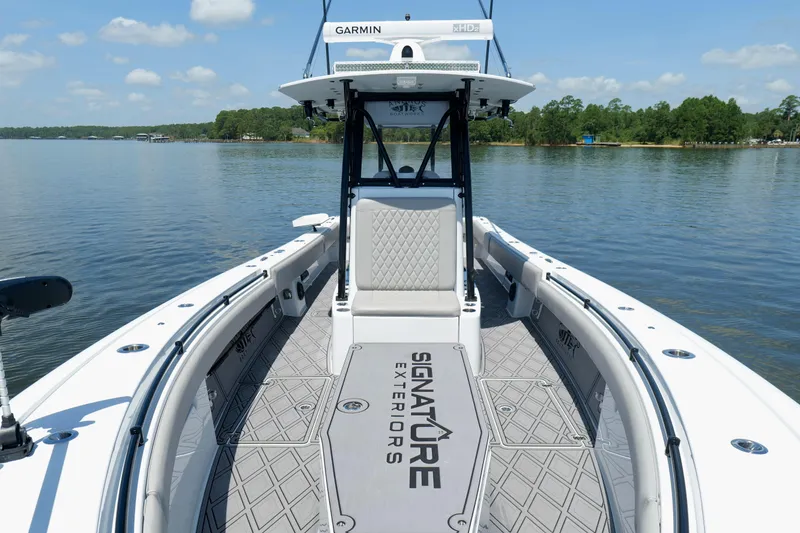 Slide: The Image of 2023 Andros 32 Offshore boat on calm lake with clear sky and lush shoreline. - 33