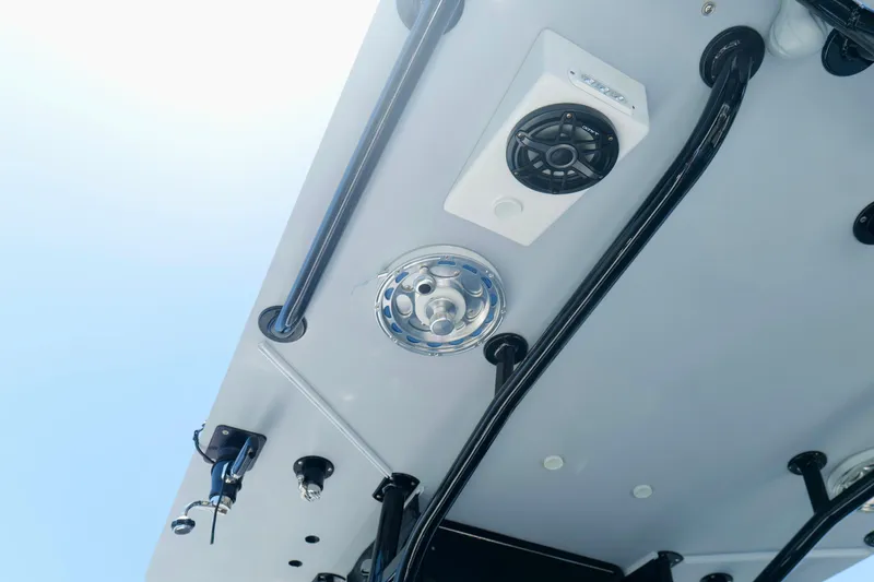 Slide: The Image of 2023 Andros 32 Offshore boat ceiling with speakers and rods against blue sky. - 17