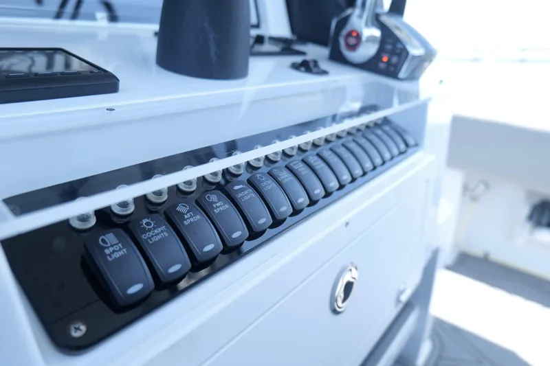 Slide: The Image of Control panel of 2023 Andros 32 Offshore boat with labeled switches. - 14