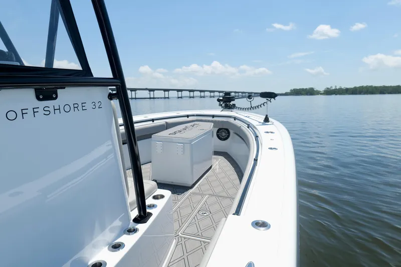 Slide: The Image of 2023 Andros 32 Offshore boat on calm water, featuring sleek design and spacious deck. - 32