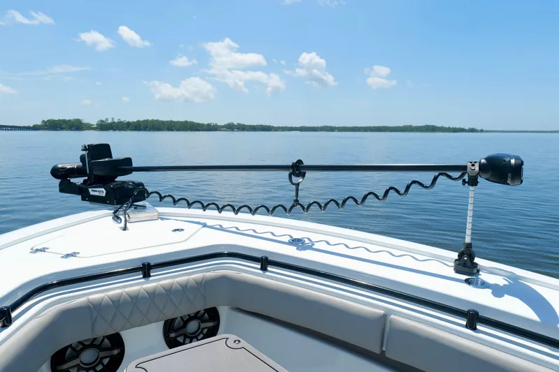 Slide: The Image of 2023 Andros 32 Offshore boat with trolling motor on calm water under blue sky. - 38