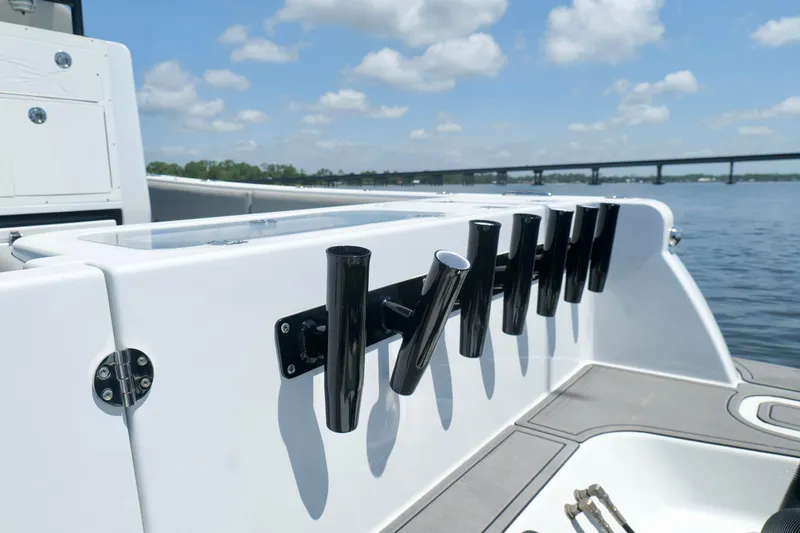Slide: The Image of 2023 Andros 32 Offshore boat with rod holders, on a sunny day by the water. - 23